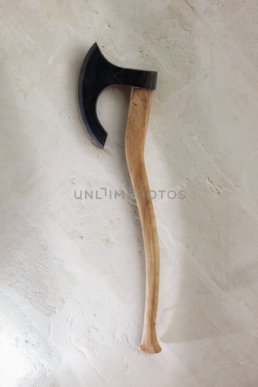 Ancient battle axe on the stone background white wall. With clipping path