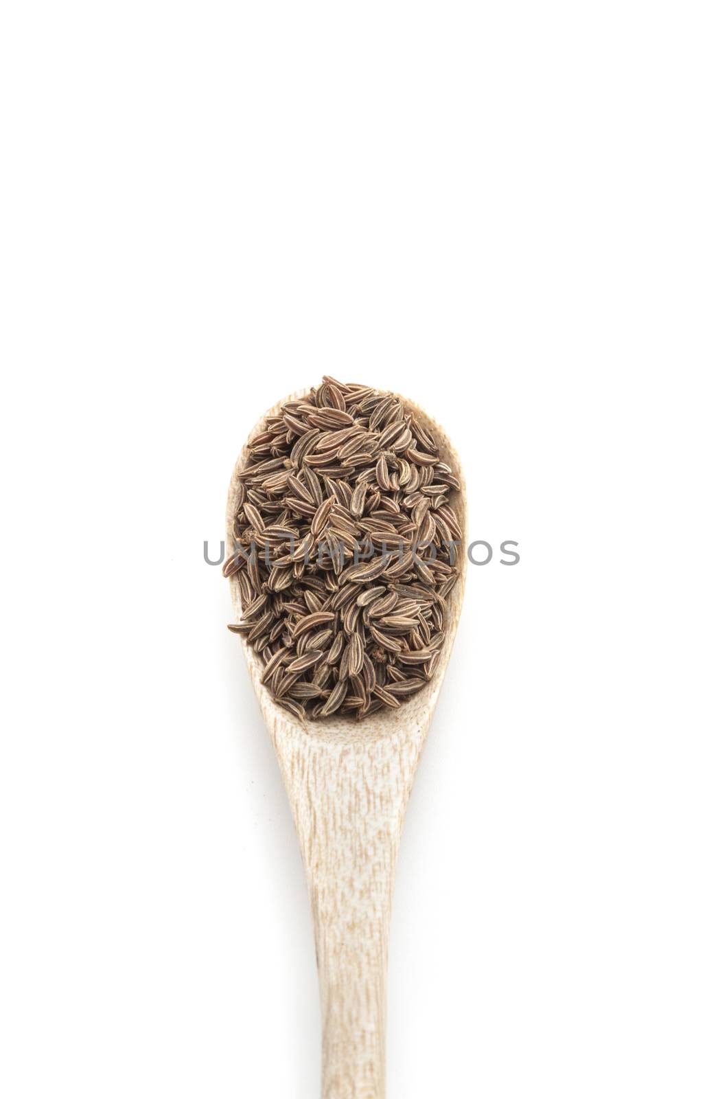 Cumin dry spice in wooden spoon isolated on white background