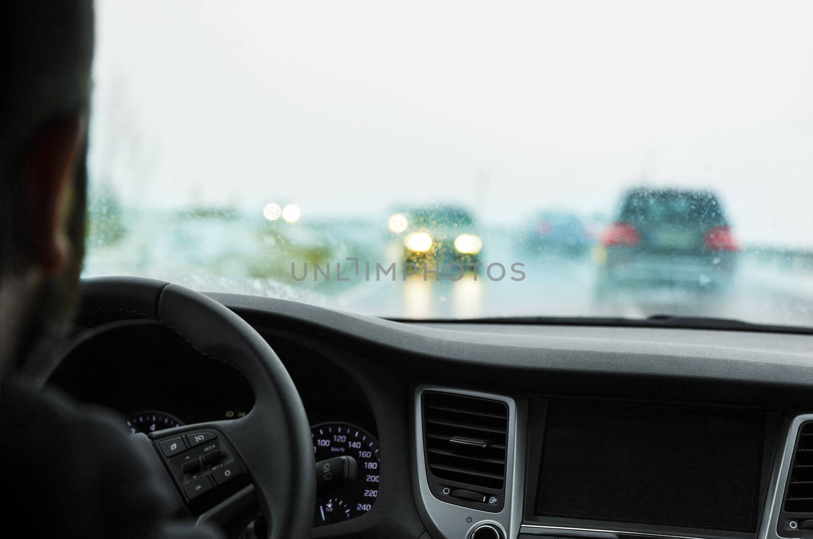 Driving in snowfall. Inside view of the car