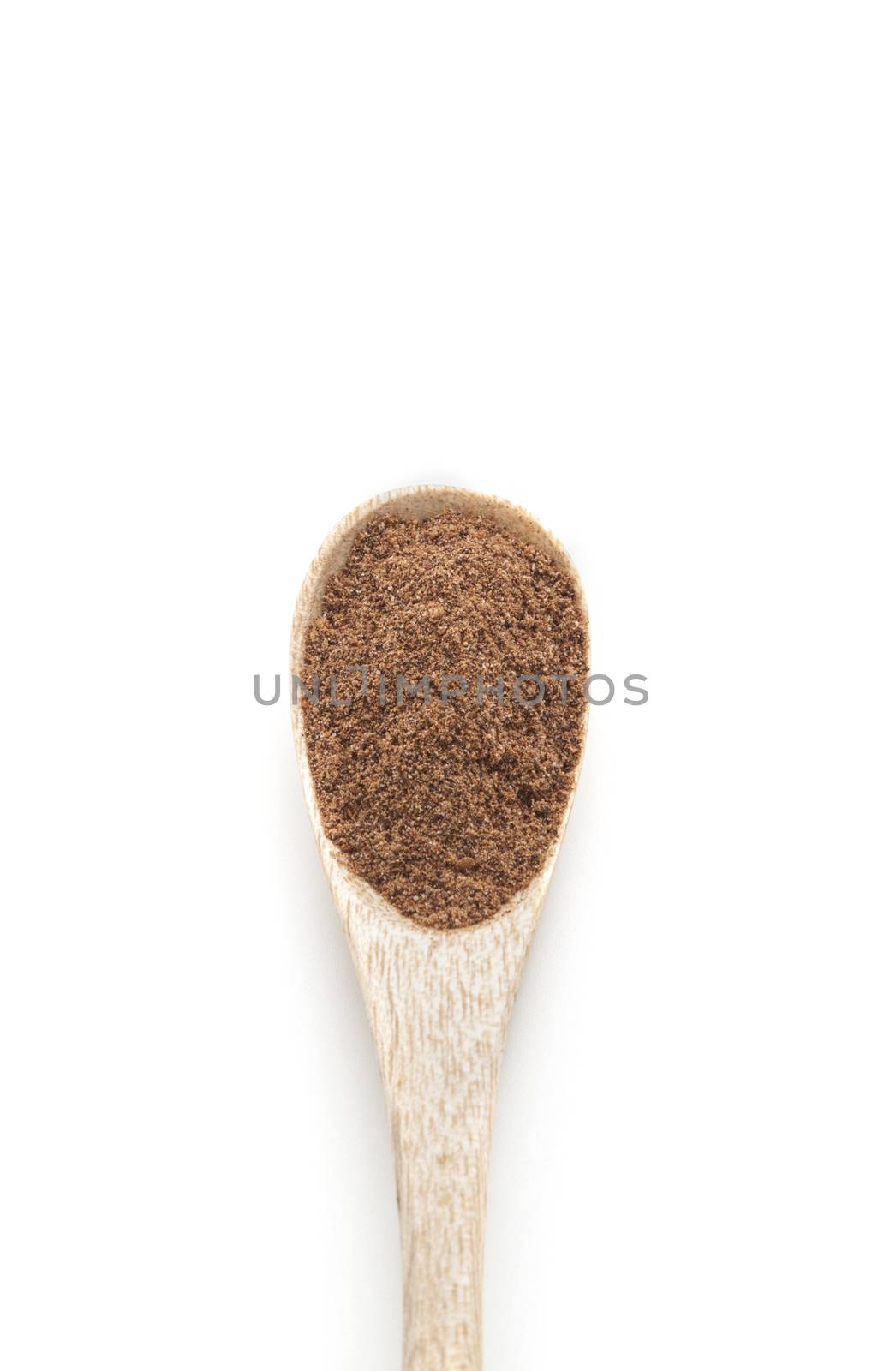 Ground nutmeg spices in wooden spoon isolated on white background