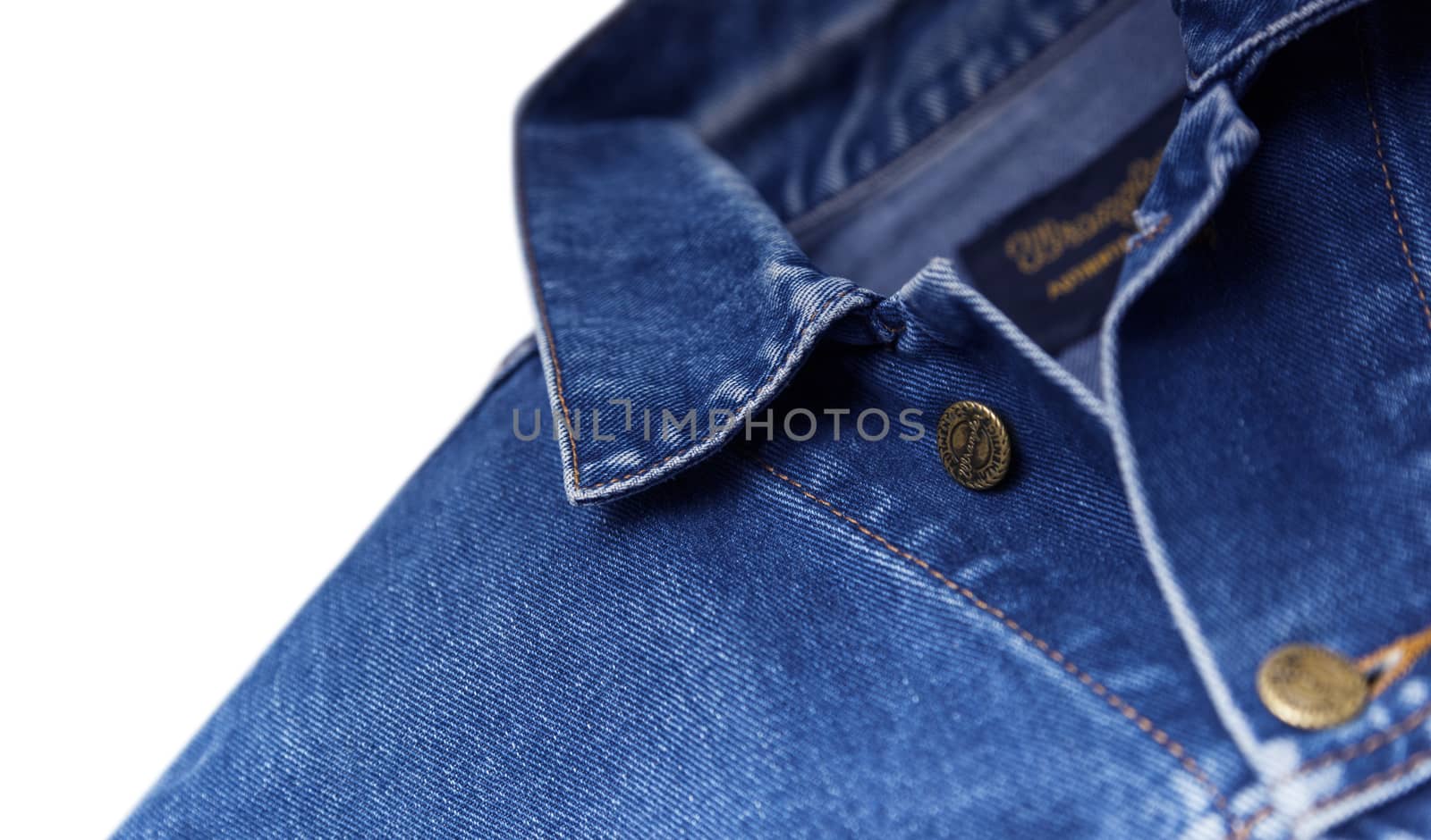 CHISINAU, MOLDOVA - December 25, 2017: Jeans jacket Wrangler blue color, isolated on white background. The Wrangler brand is owned by VF Corporation of Greensboro, North Carolina USA. Top view, blurred concept