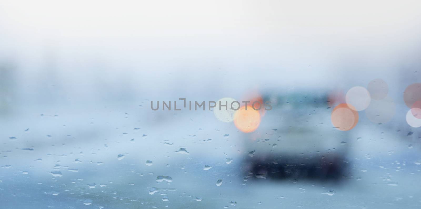 Rainy day, raindrops on the car window with traffic bokeh light by SlayCer