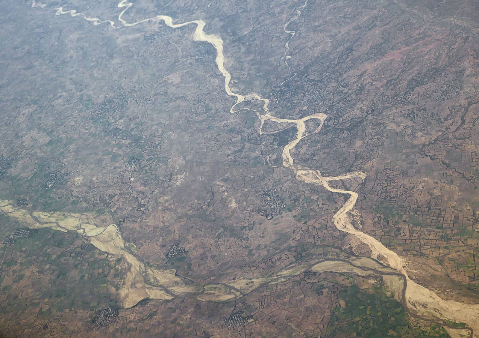 Dry land and riverbeds view from airplane