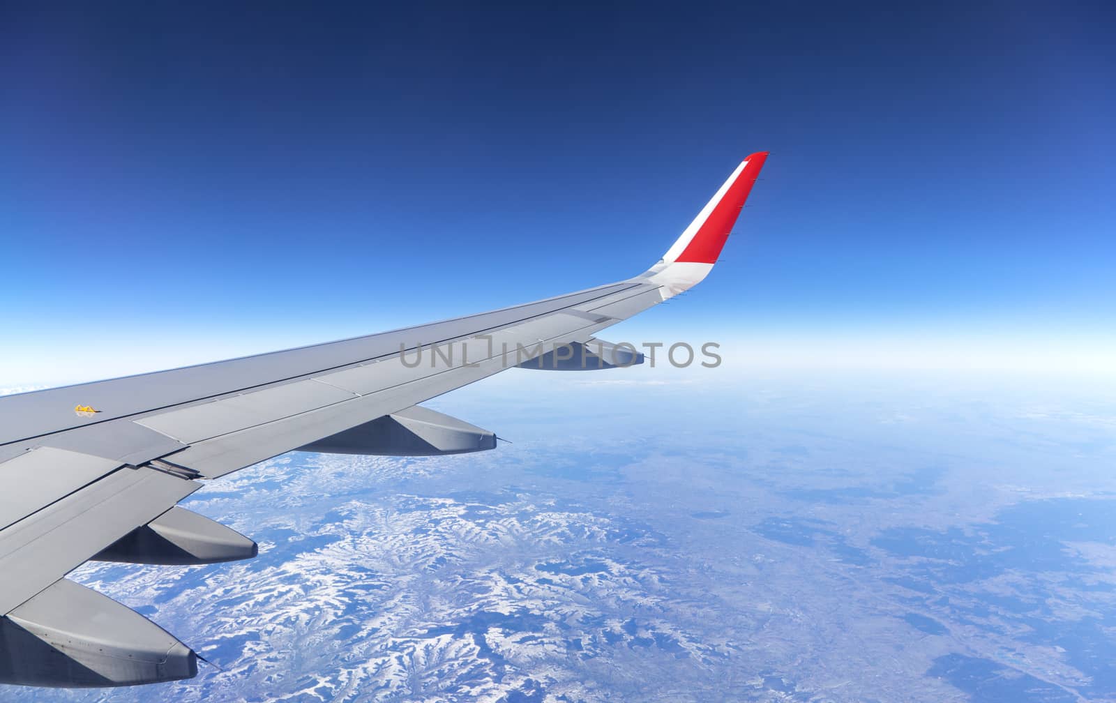 Wing of an airplane and the land below