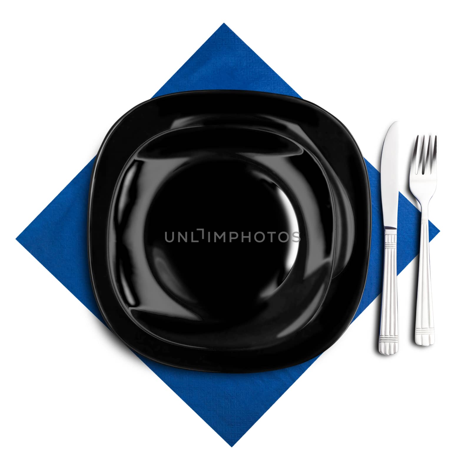 Black plate, fork and knife on blue napkin. Isolated on white.