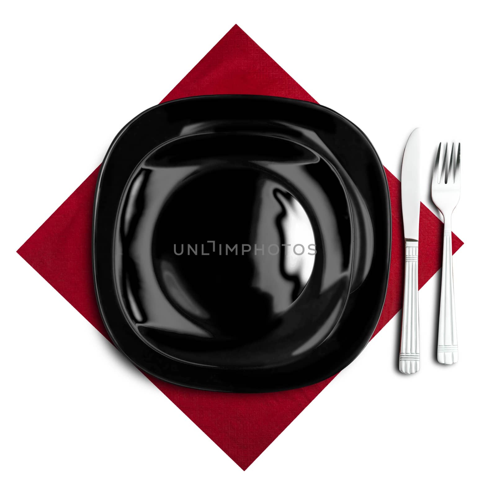 Black plate, fork and knife on red napkin. Isolated on white.