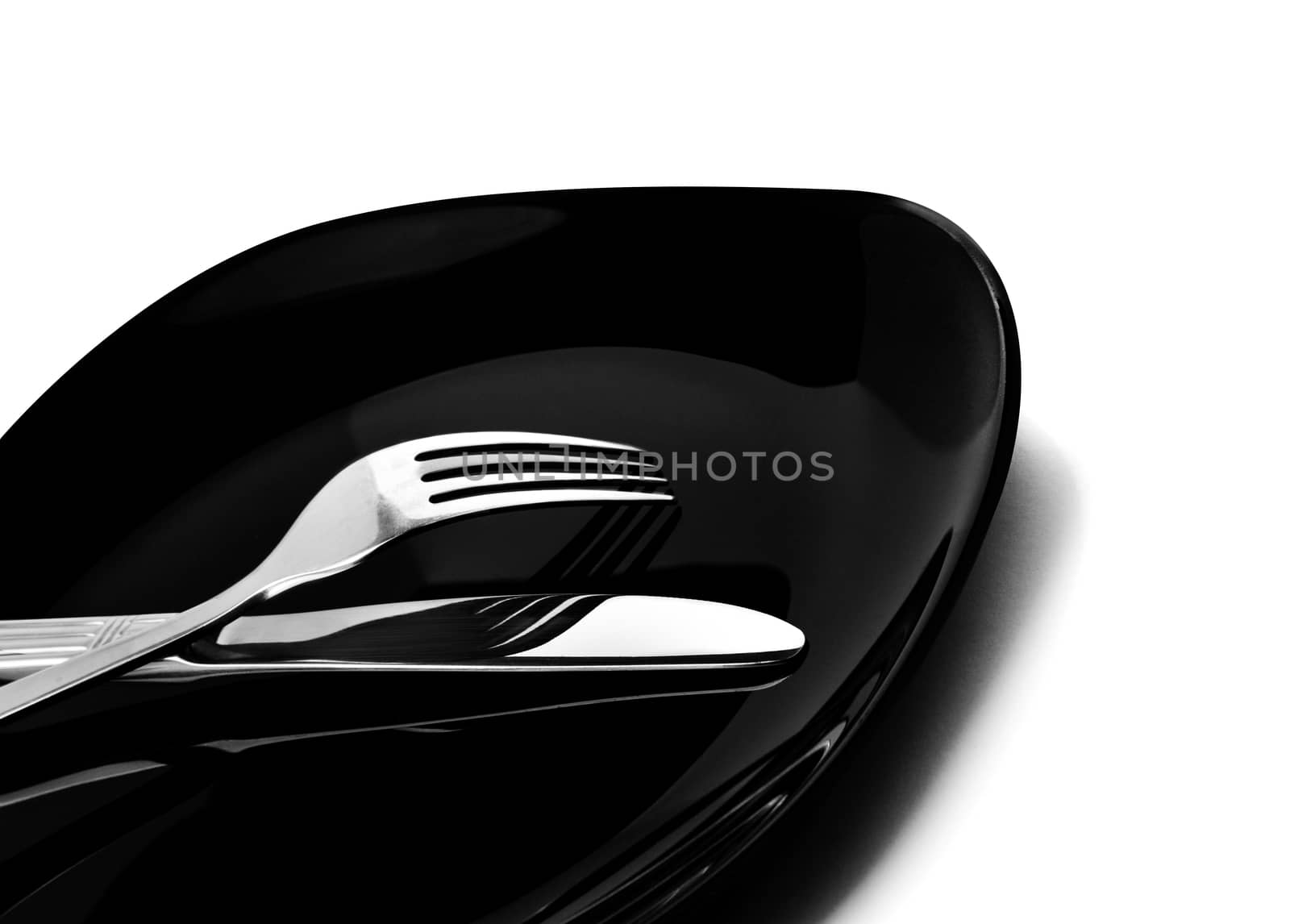 Knife and fork at plate on white background. With clipping path