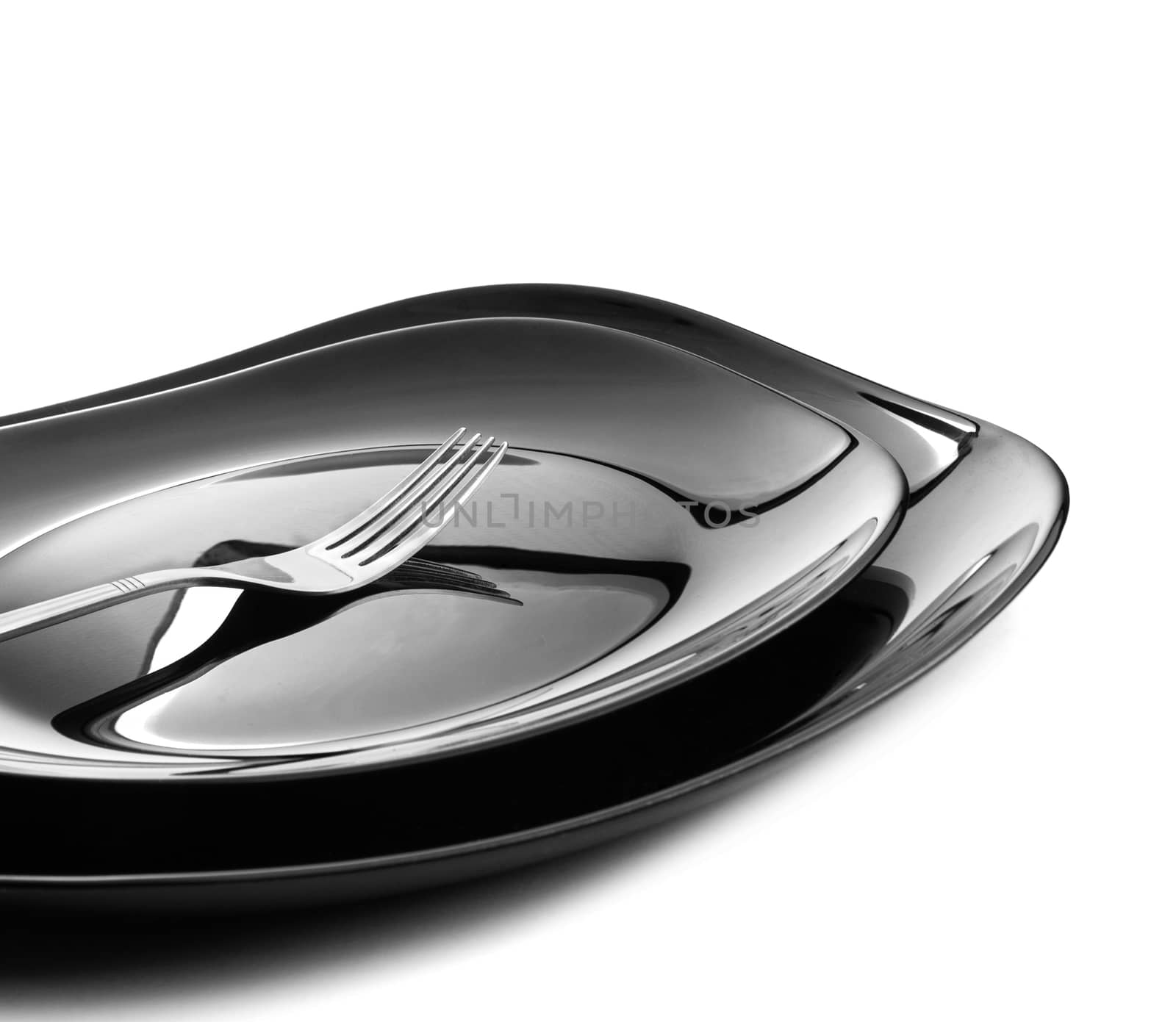 Fork at two black plates on white background