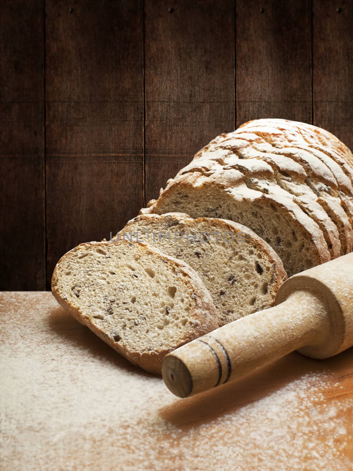 Sliced rye bread with linseed on wooden background. With clipping path