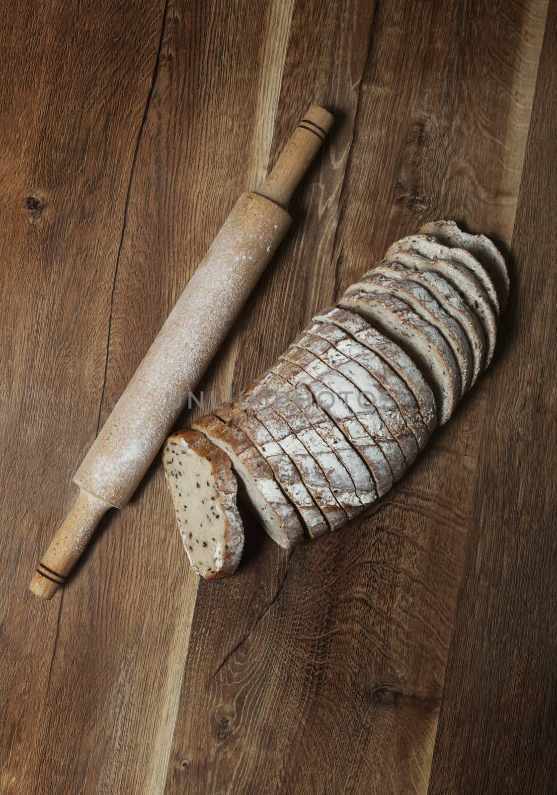 Sliced rye bread with linseed on wooden background. With clipping path