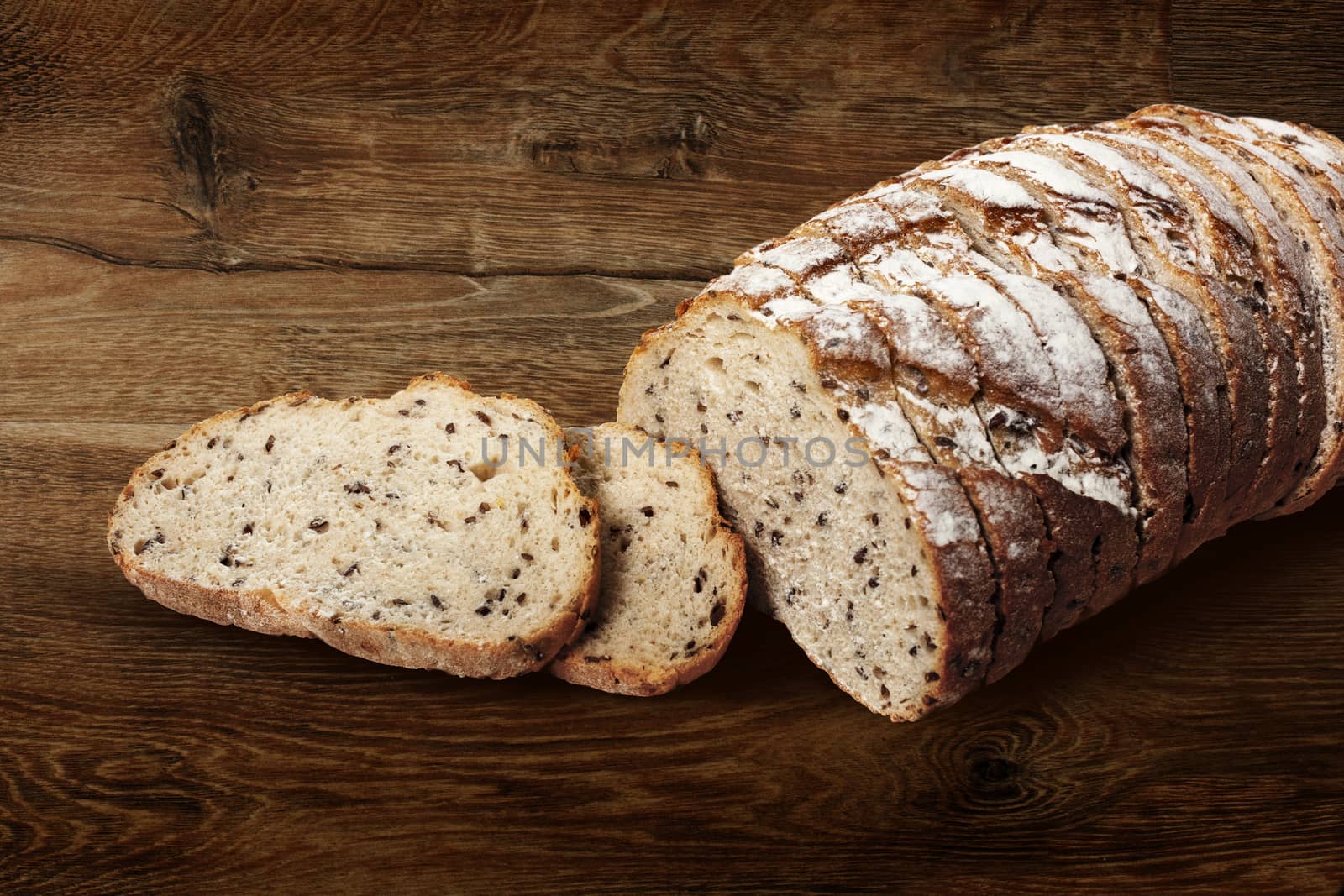 Sliced rye bread with linseed on wooden background. With clipping path