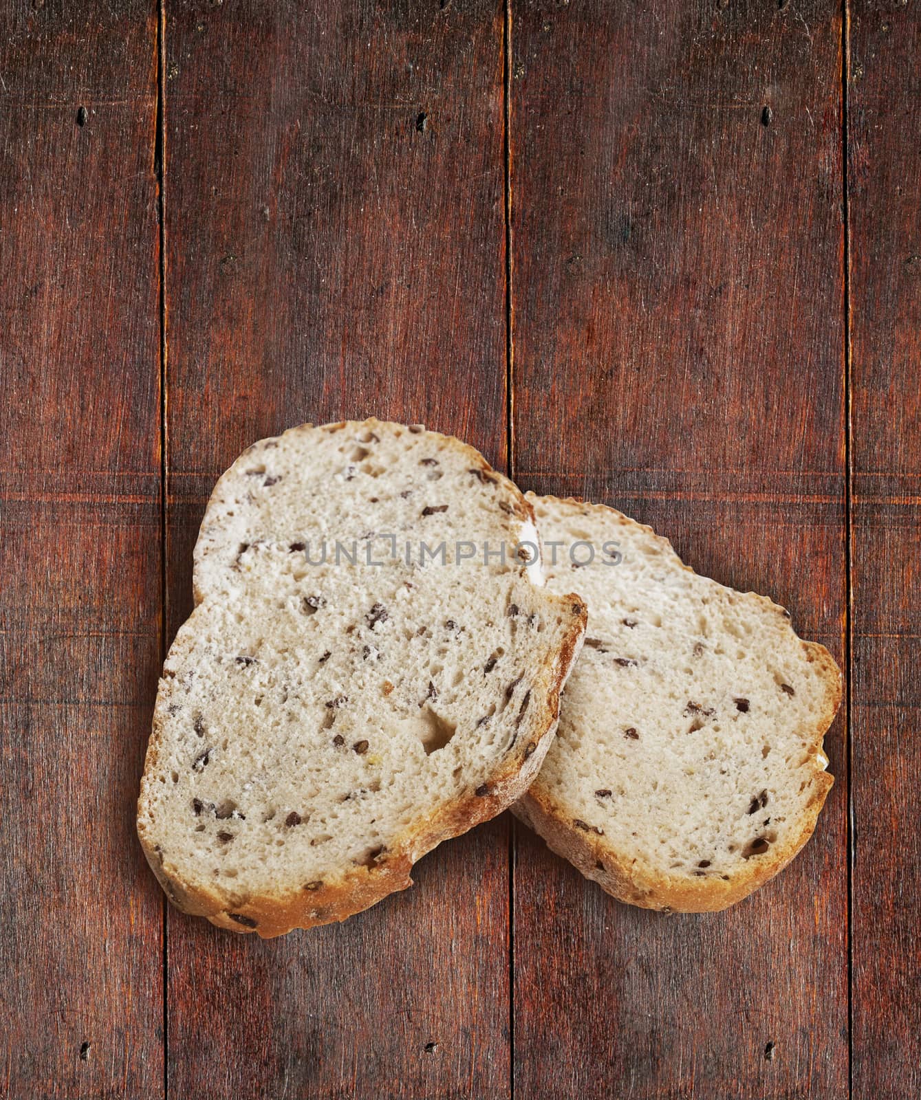 Sliced rye bread with linseed on wooden background. With clipping path