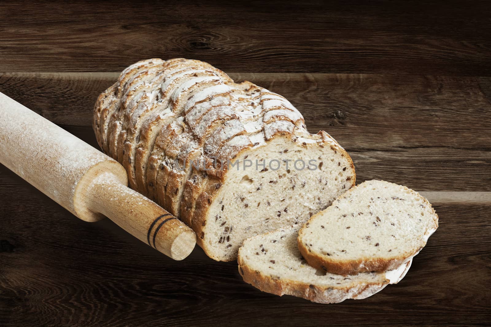 Sliced rye bread with linseed on wooden background. With clipping path
