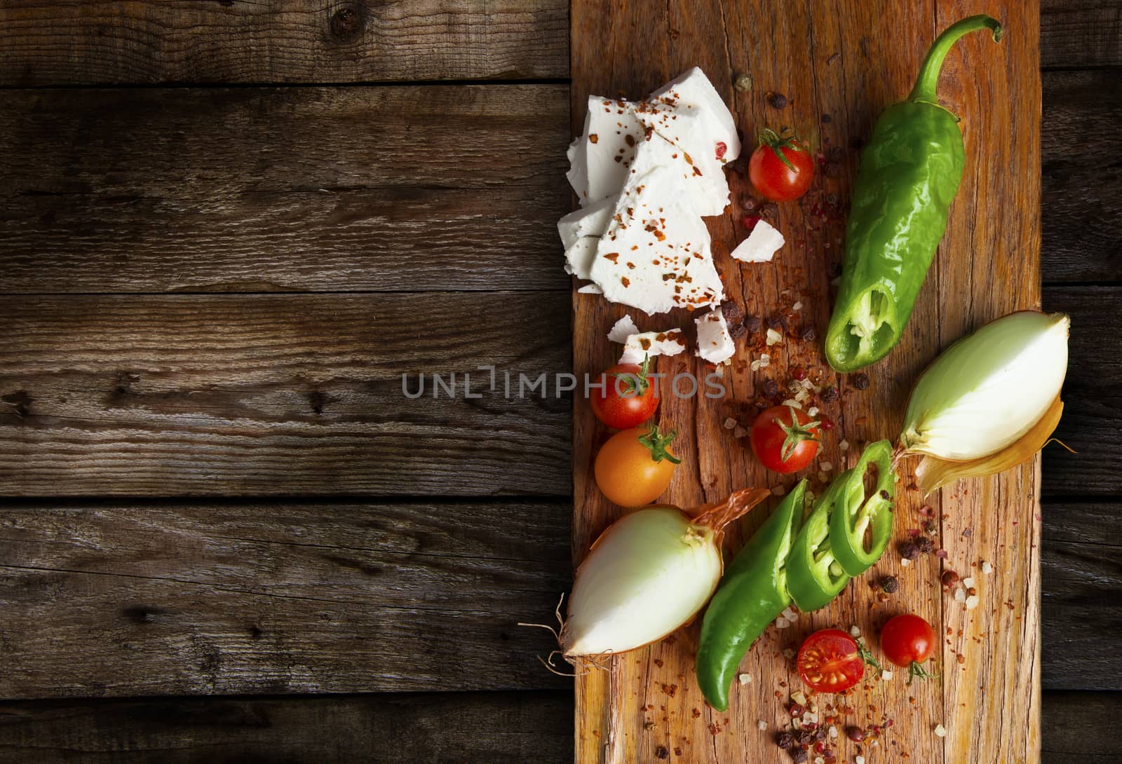 Table top full of fresh vegetables, cheese, traditional Balkan foods with a space in the for text.