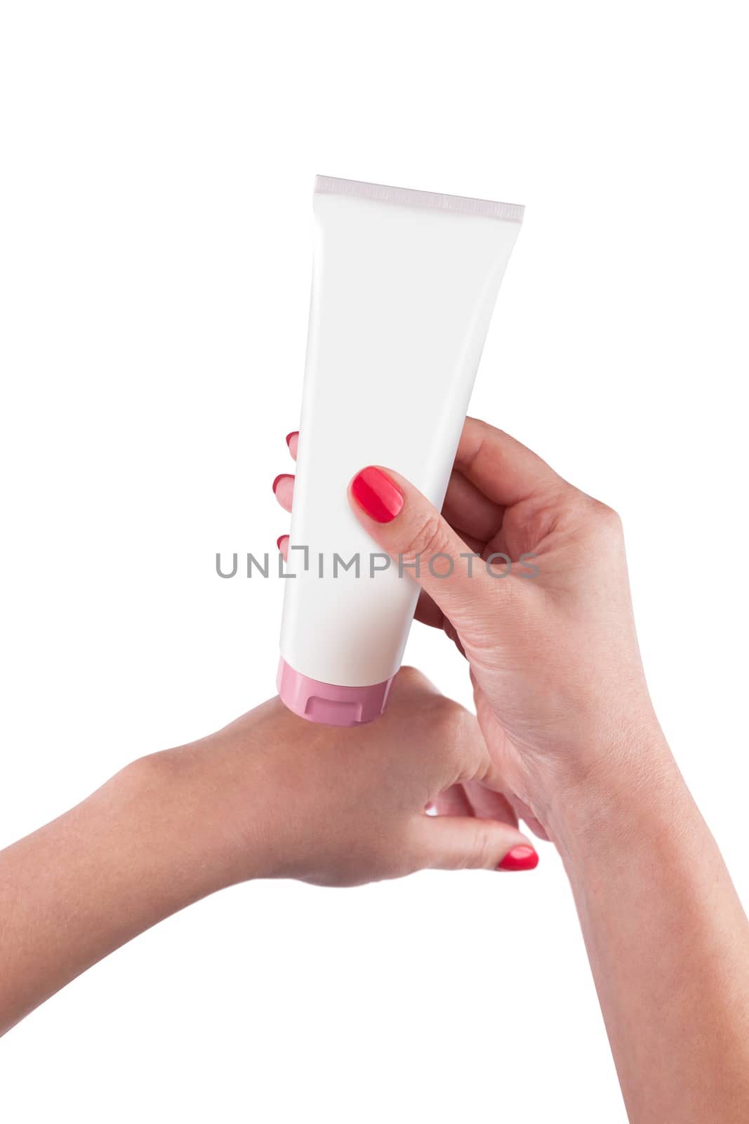 Hand holding cream tube isolated on white background. With clipping path