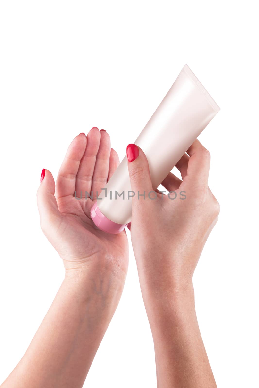 Hand holding cream tube isolated on white background. With clipping path