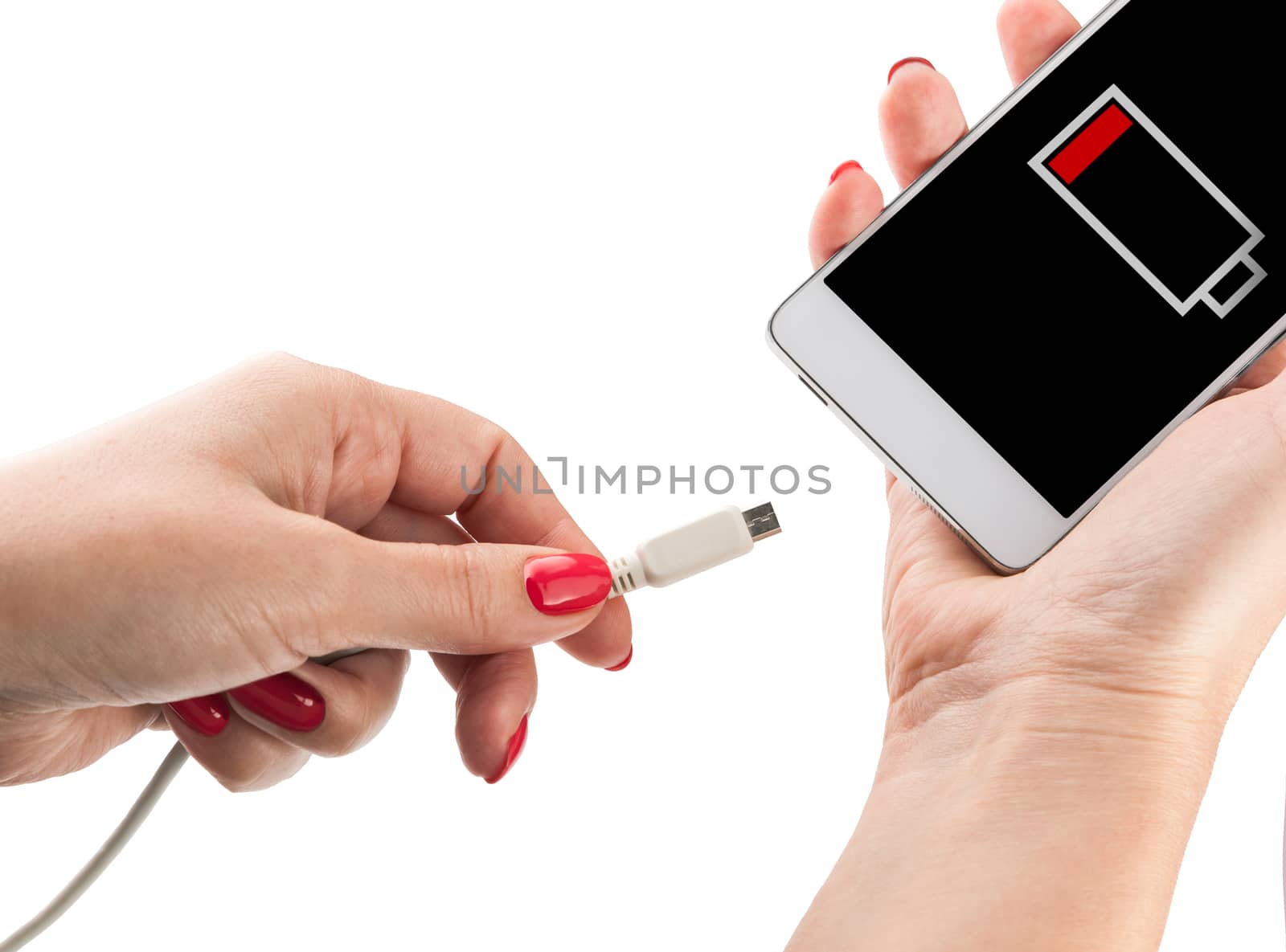 Female hand holding low battery smartphone and connect charger isolated on white background