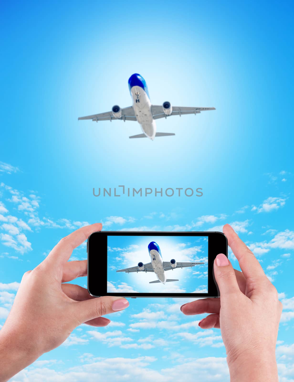 Female Hand holding using mobile phone and airplane on a blue background