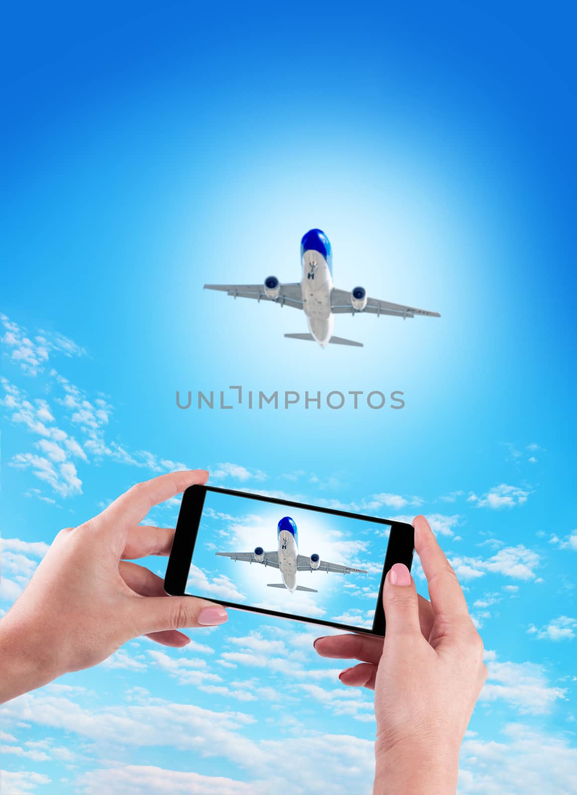 Female Hand holding using mobile phone and airplane on a blue background