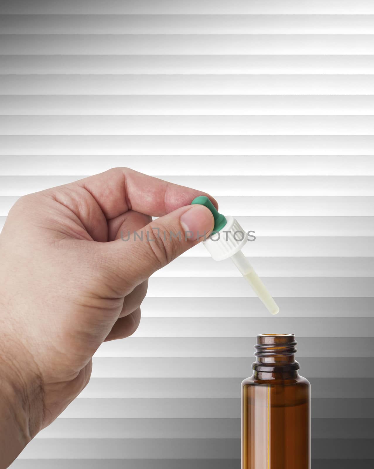 Hand man scientist, doctor keeps the pipette for drop over the container with liquid, medication or chemical substance laboratory. Isolated on white of stripes background with clipping path