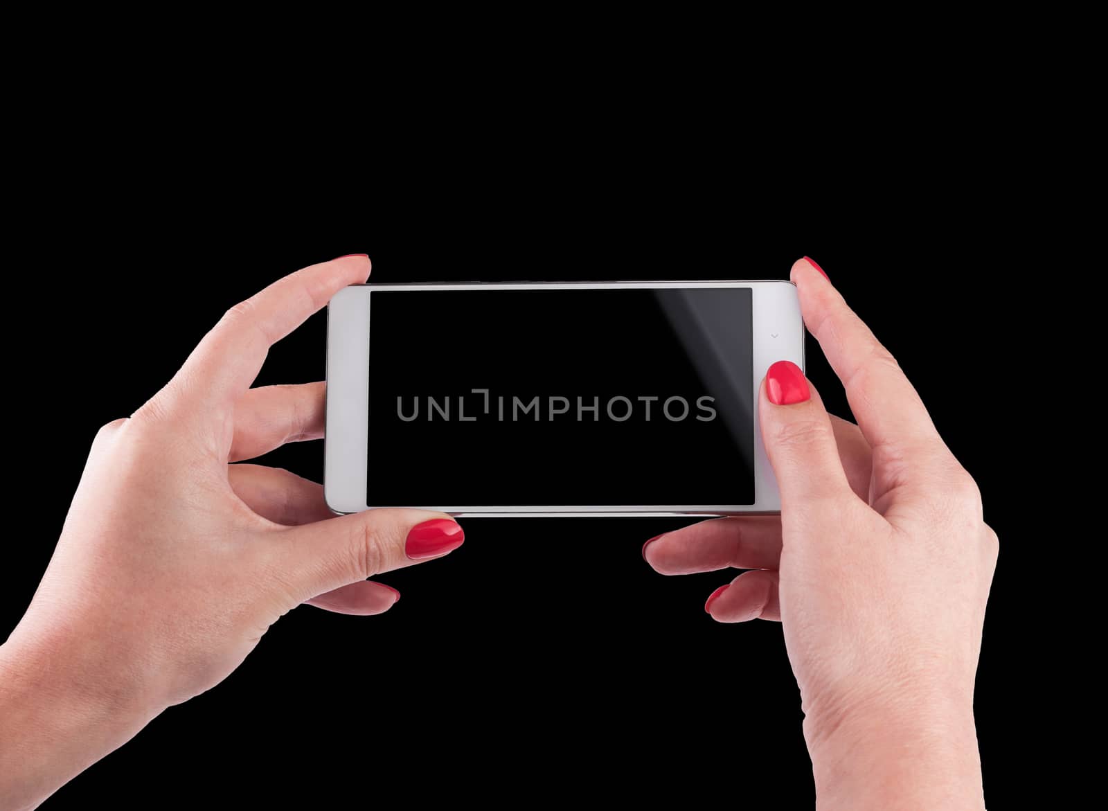 Female Hand holding and Touching a Smartphone isolated on black background.