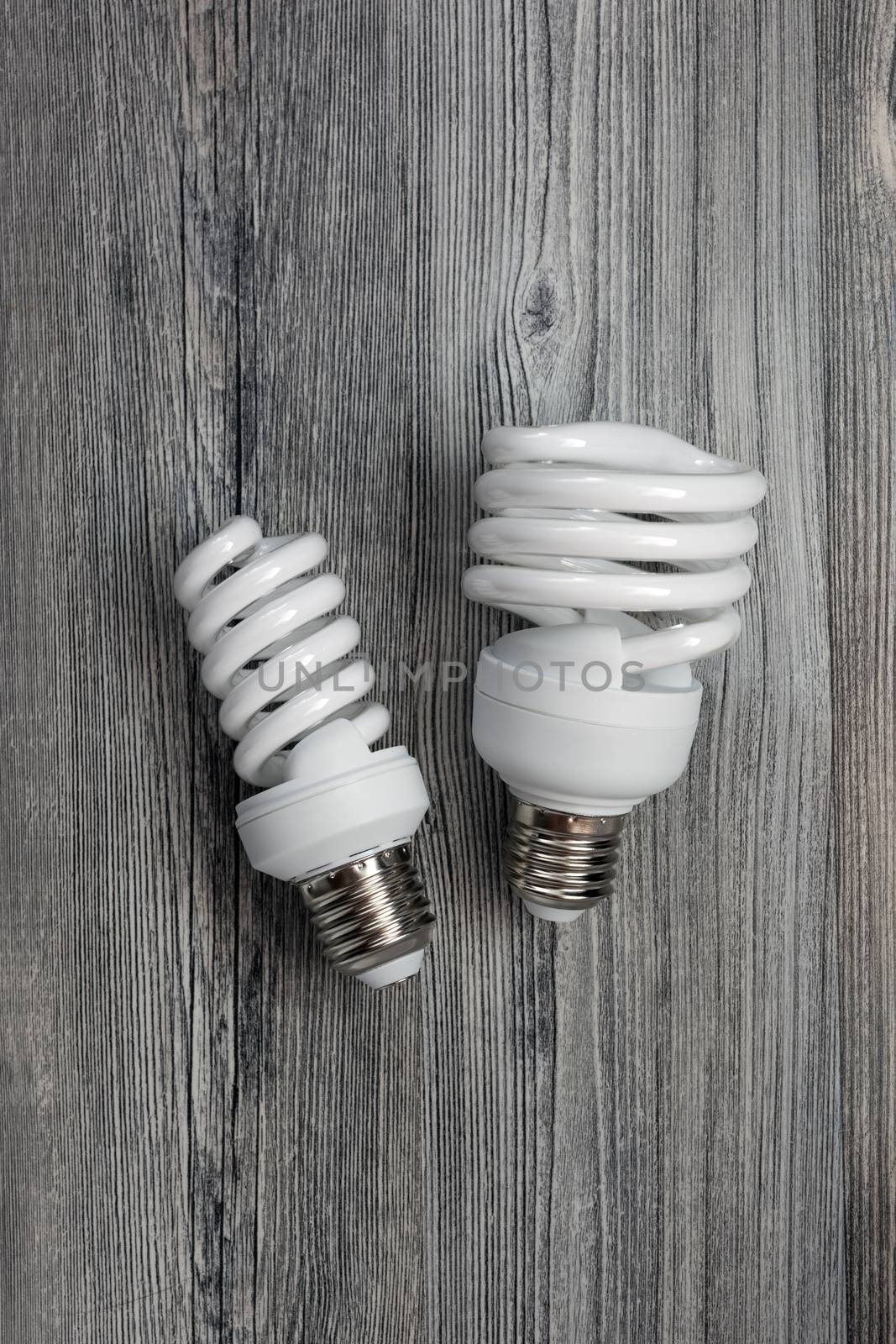 Energy saving light bulb isolated on wood table