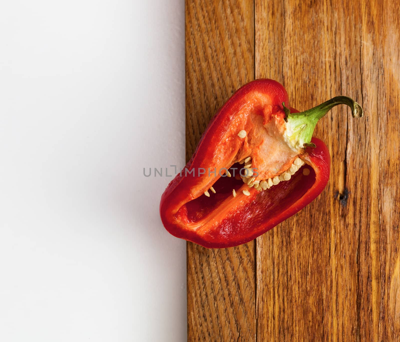 Red pepper slice on a wooden background
