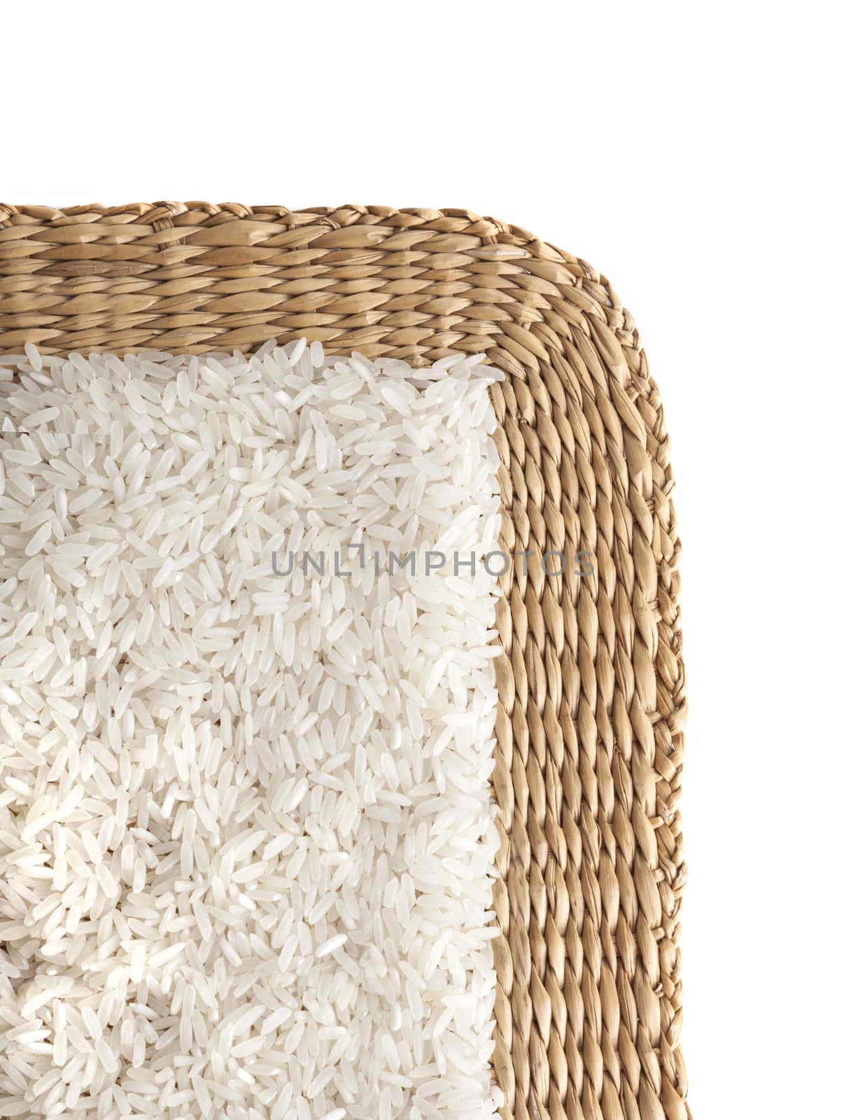 Asian uncooked white rice on a background of straw.