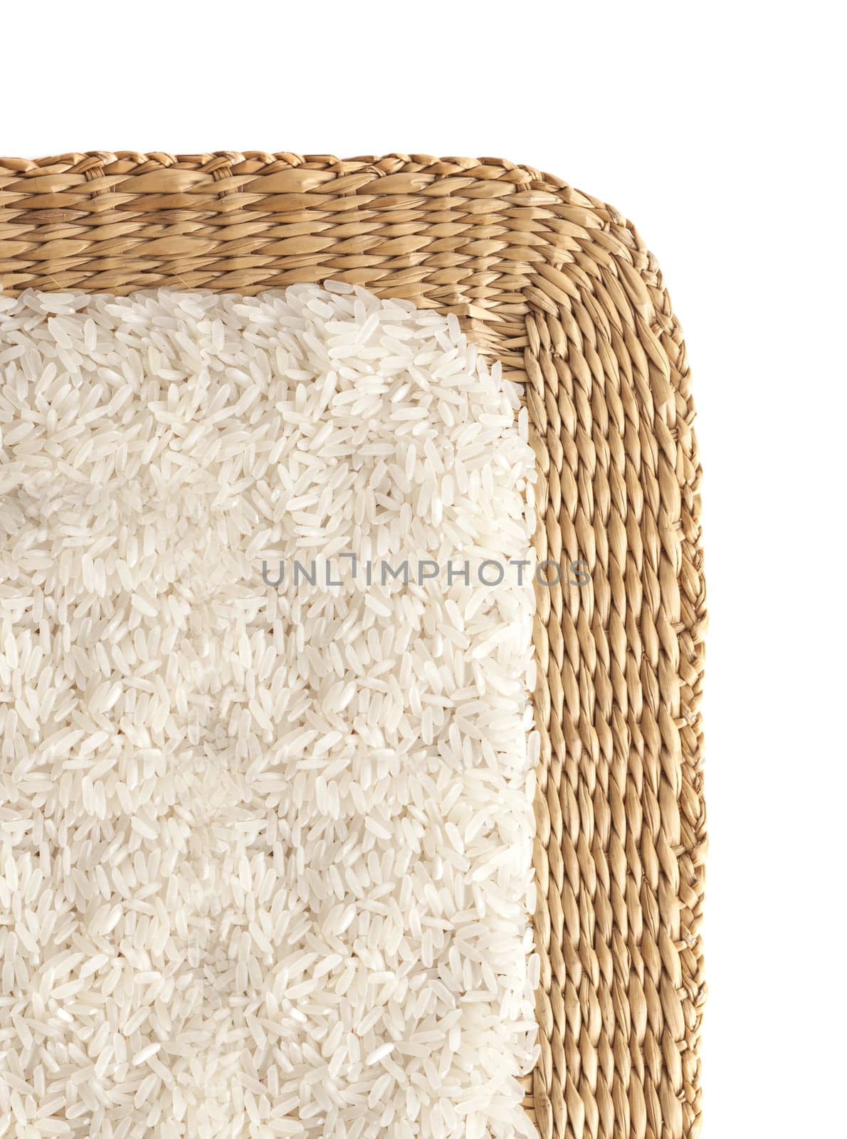 Asian uncooked white rice on a background of straw.