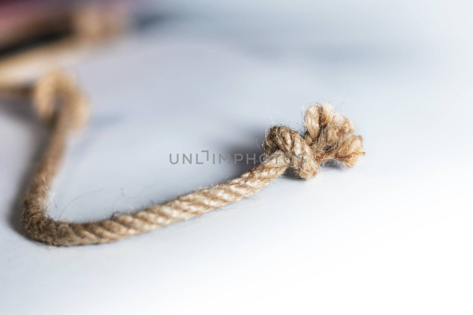Rope with knot isolated over white background. Bluren concept
