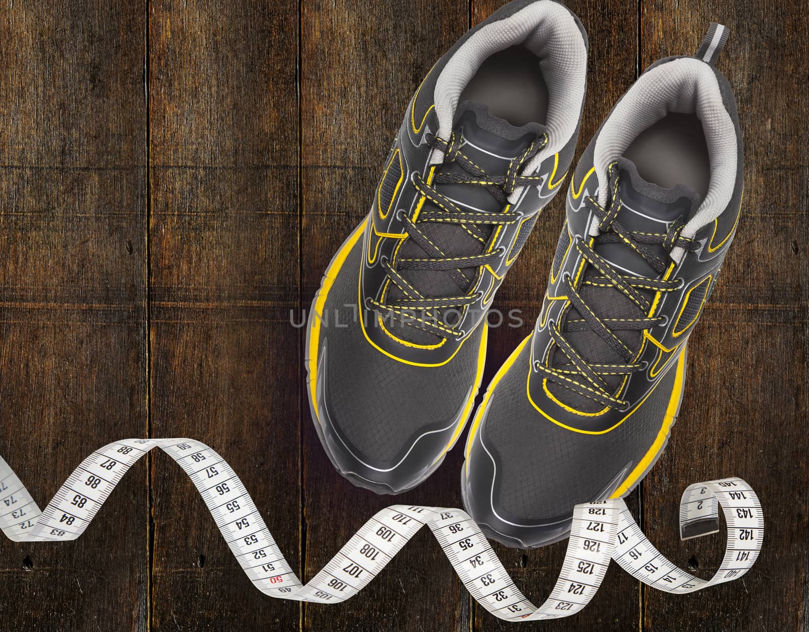 Sport shoes and measuring tape on wooden background by SlayCer