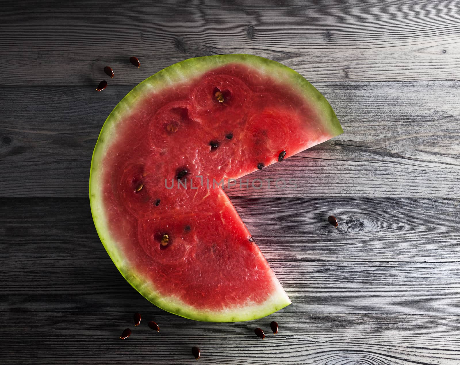 Watermelon slice on the isolated wooden background. With clipping path