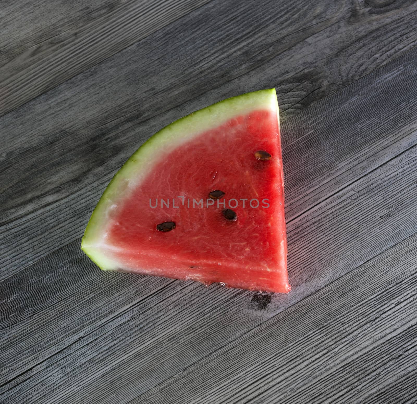 Watermelon slices on the isolated wooden table