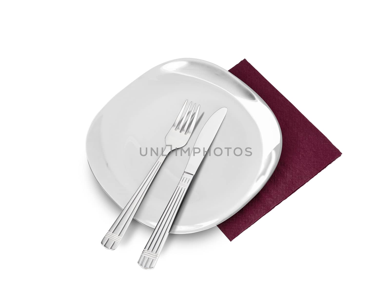 White plate, fork and knife on brown napkin. Isolated on white. With clipping path