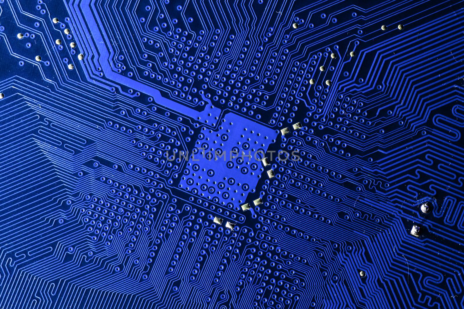 Close up photo of blue printecd circuit board with solder points