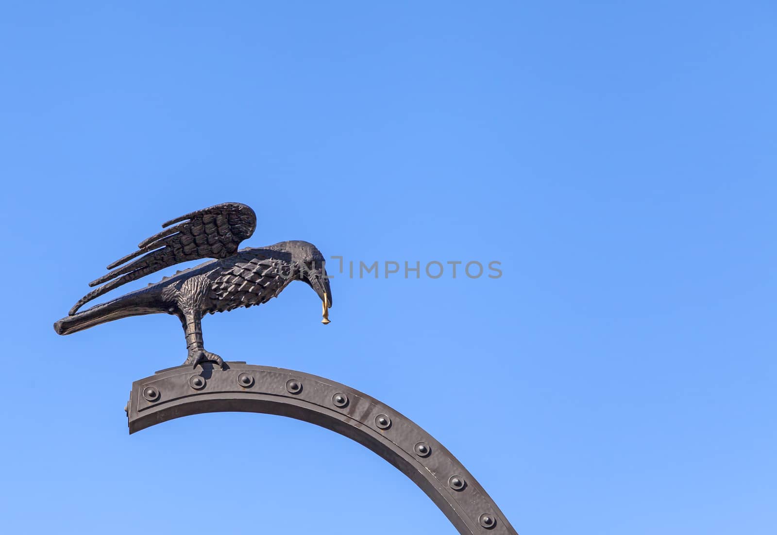 Raven carrying a gold ring on Corvin Gate of Royal Palace of Budapest, Hungary