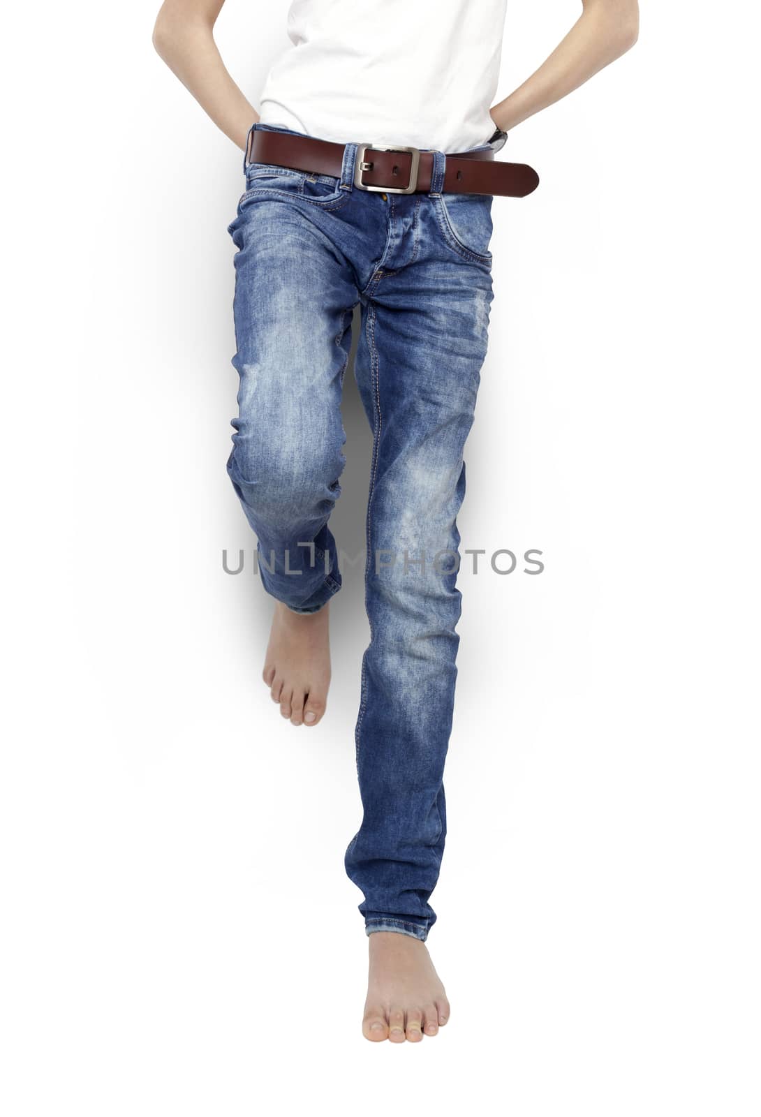 Teenager in blue jeans and a white t-shirt barefoot isolated. With clipping path