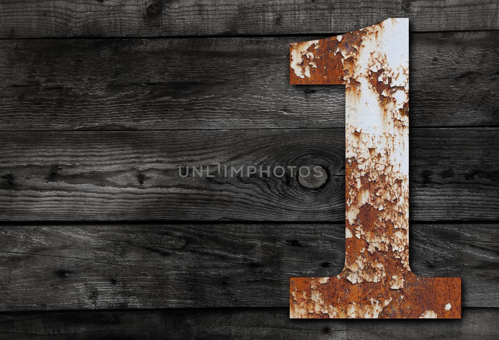 Old rusty metal alphabet, text 1 on Wooden Background nails.