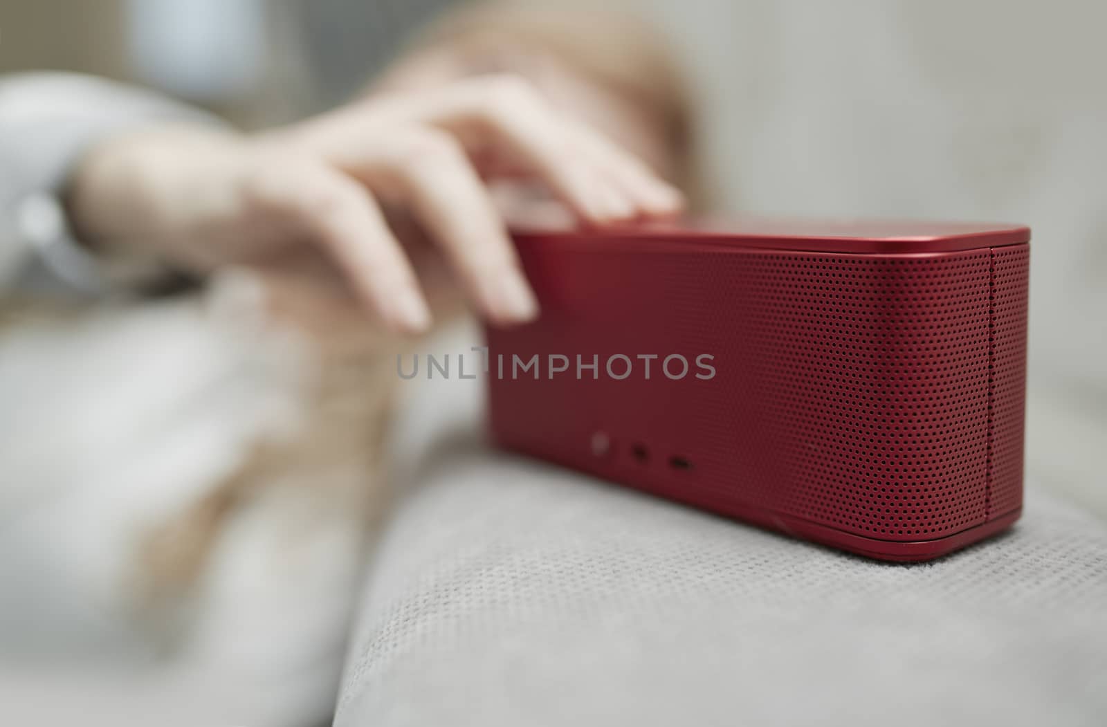 Woman using portable wireless speaker