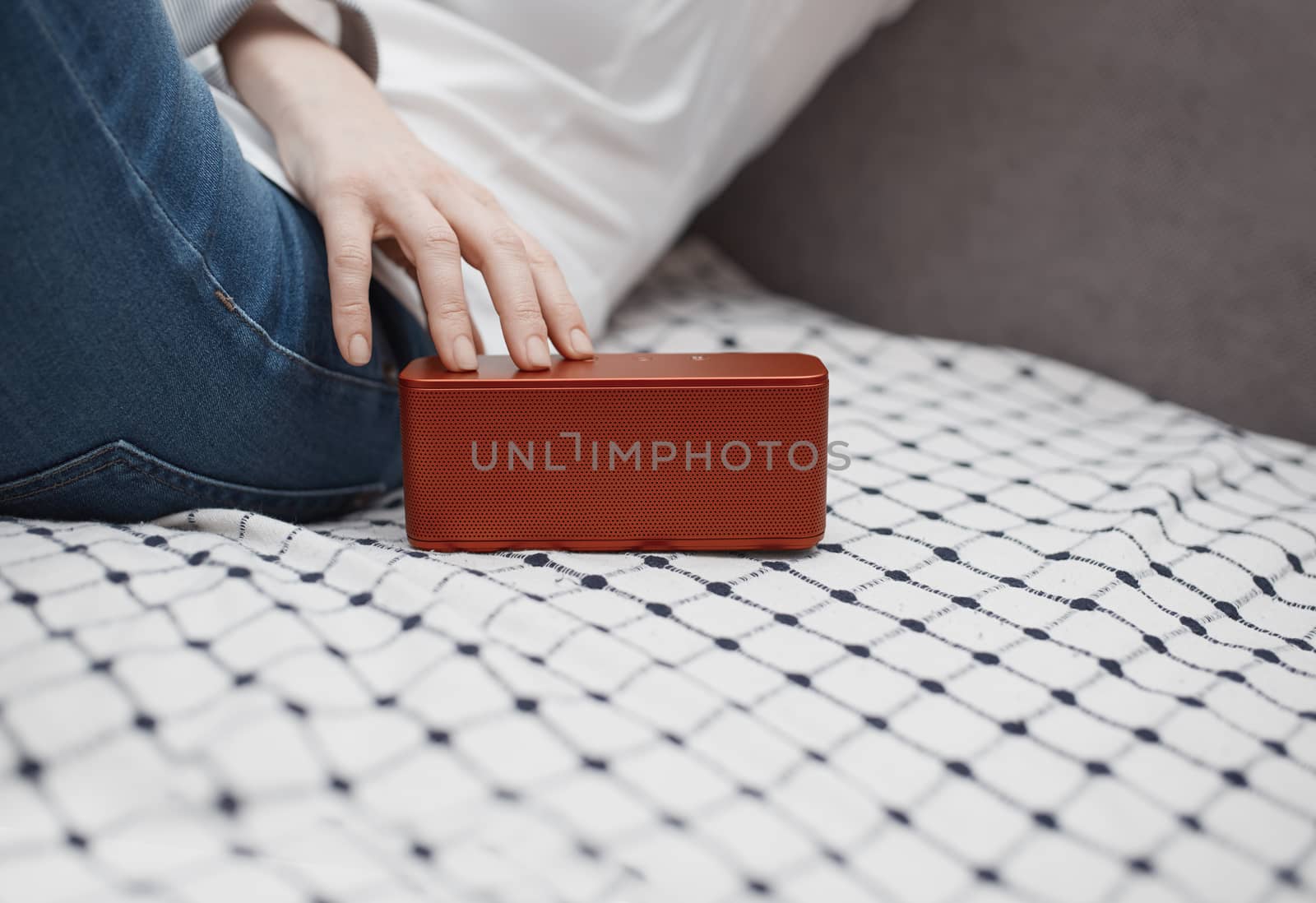 Woman using portable wireless speaker