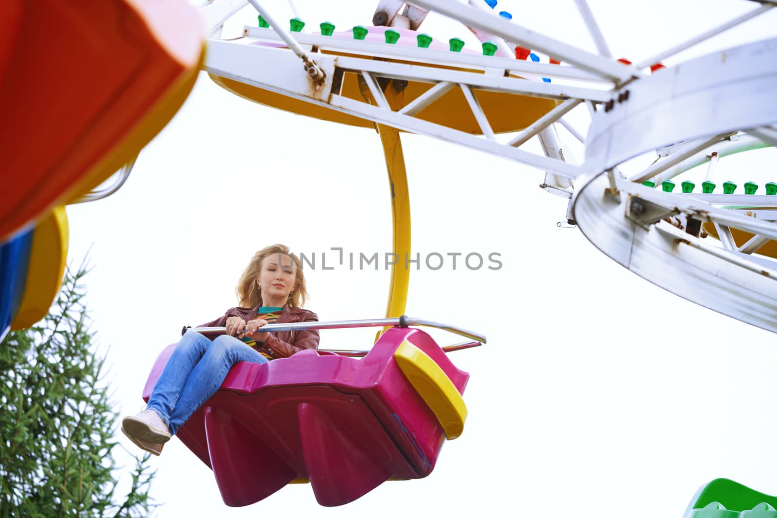 Scared or boring woman riding on rollercoaster