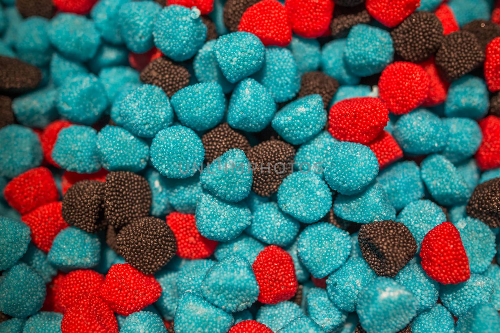 Blue black and red candies in the form of raspberries and blackberries by petrsvoboda91