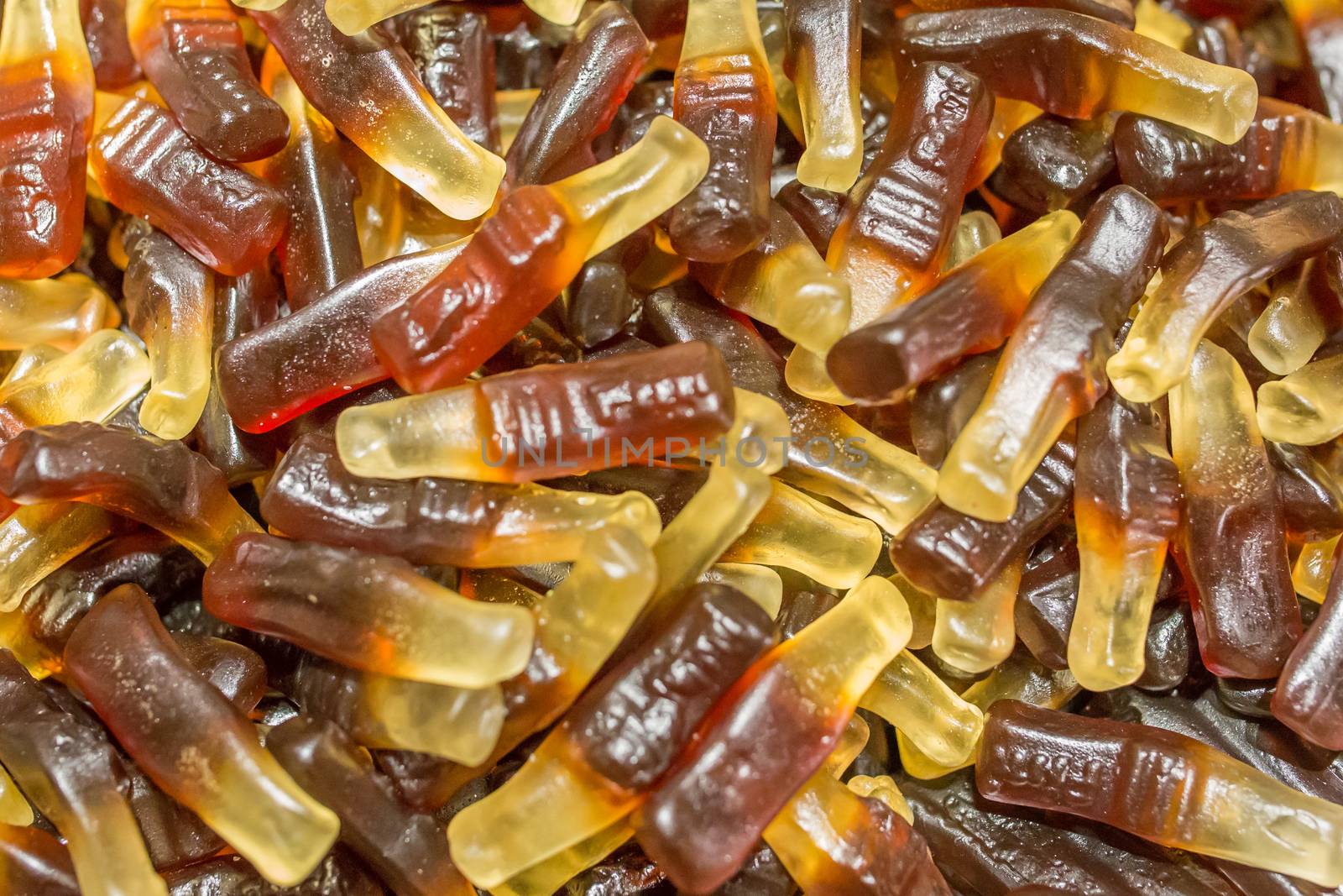 Jelly-candy texture, cola flavor, shape of cola bottles. Candy store photo.