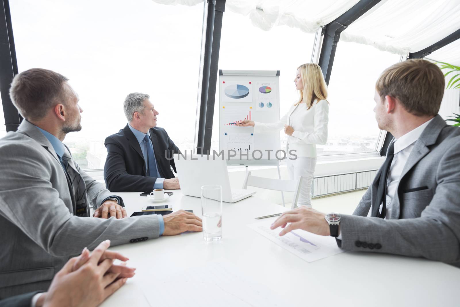 Businesswoman pointing at a chart on a whiteboard during business meeting