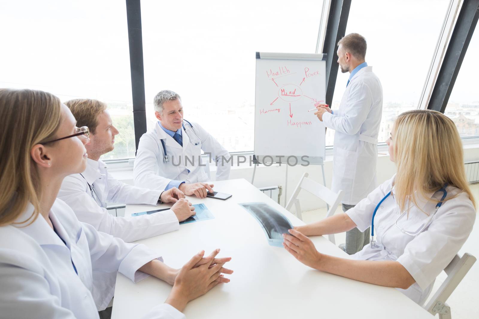 Team of doctors discuss mental health concept at presentation in clinical office