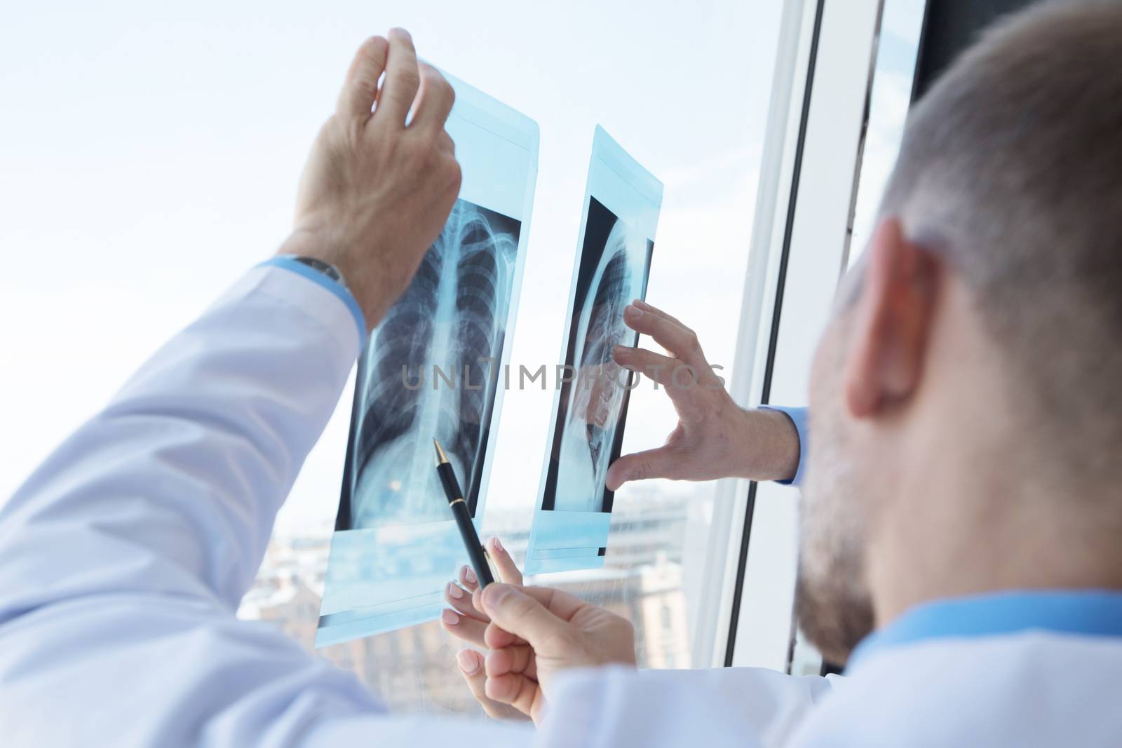 Group of doctors look and discuss x-ray in a clinic or hospital