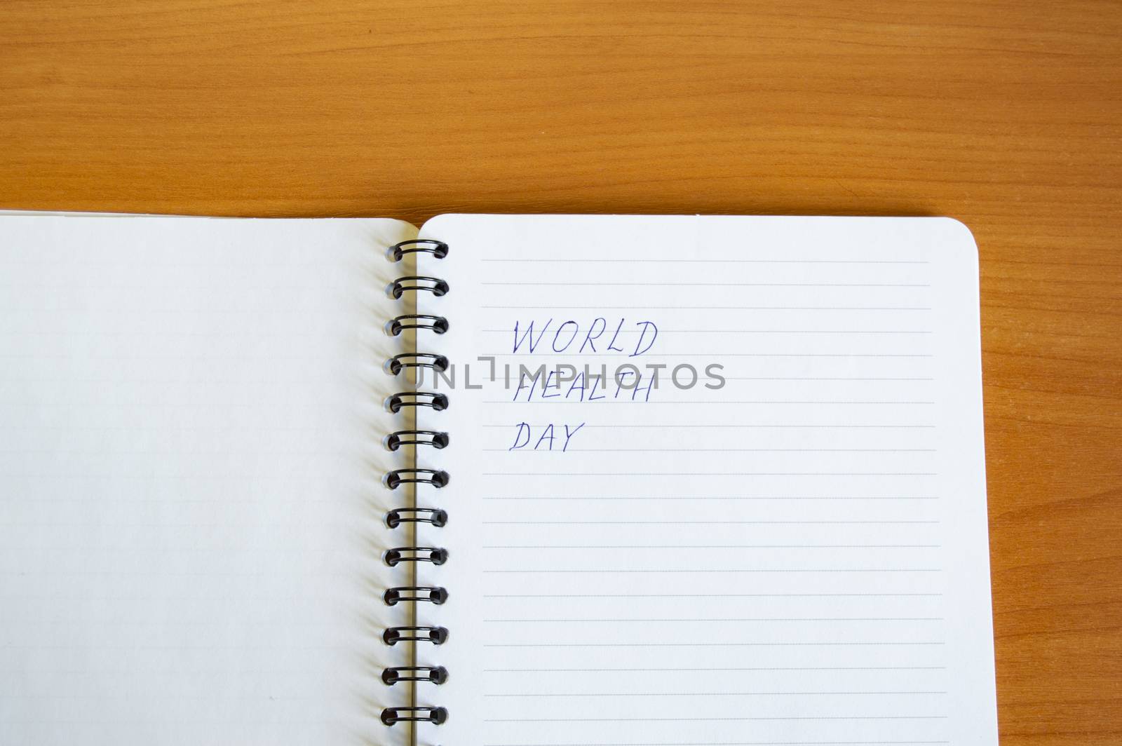 Notepad with text world health day on wooden table, health concept, minimalism style copy space by claire_lucia