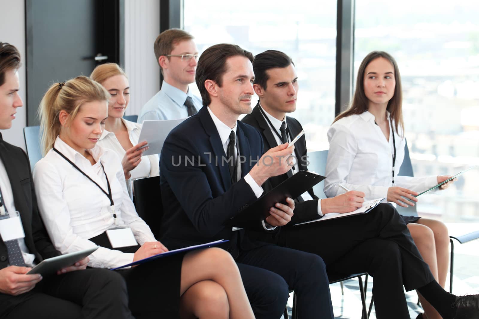 Audience of business people at conference or seminar