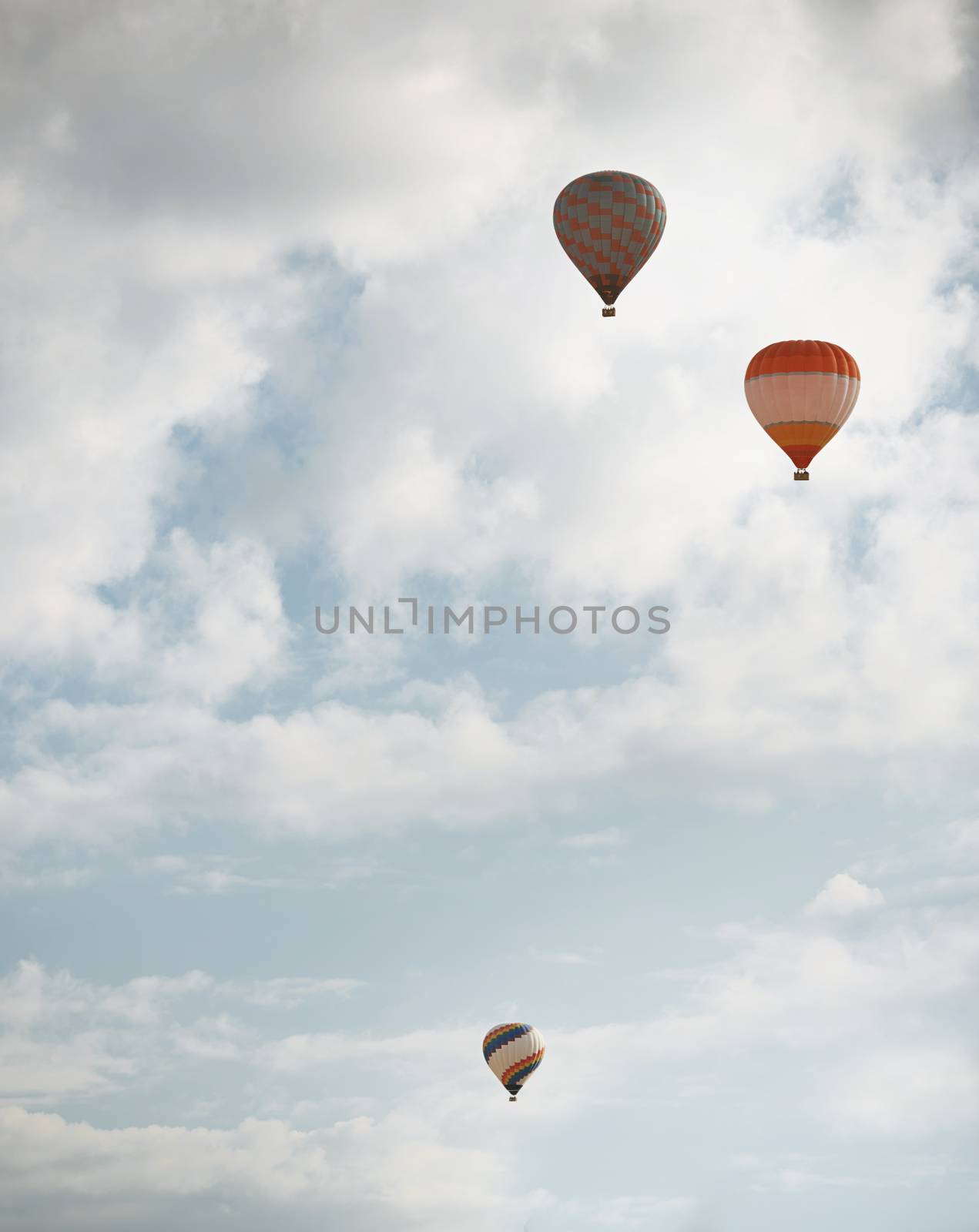 Three hot air balloons flying in the sky