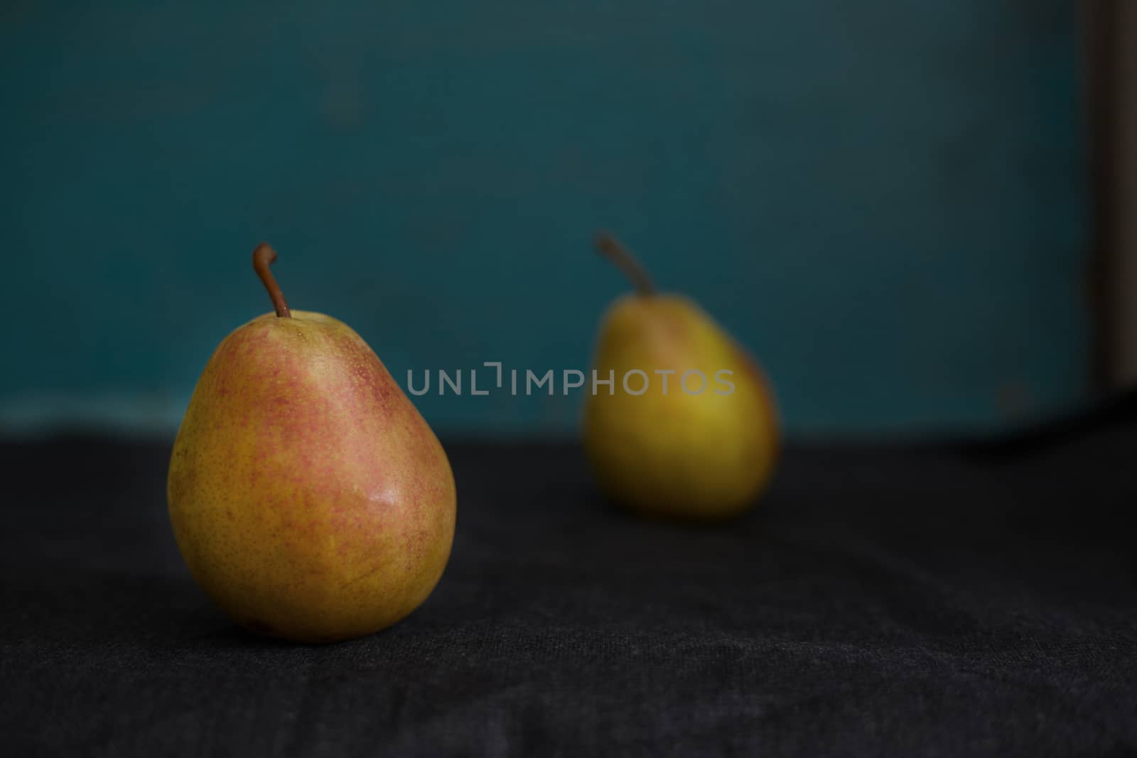 Two fresh pears on a table. Close-up view